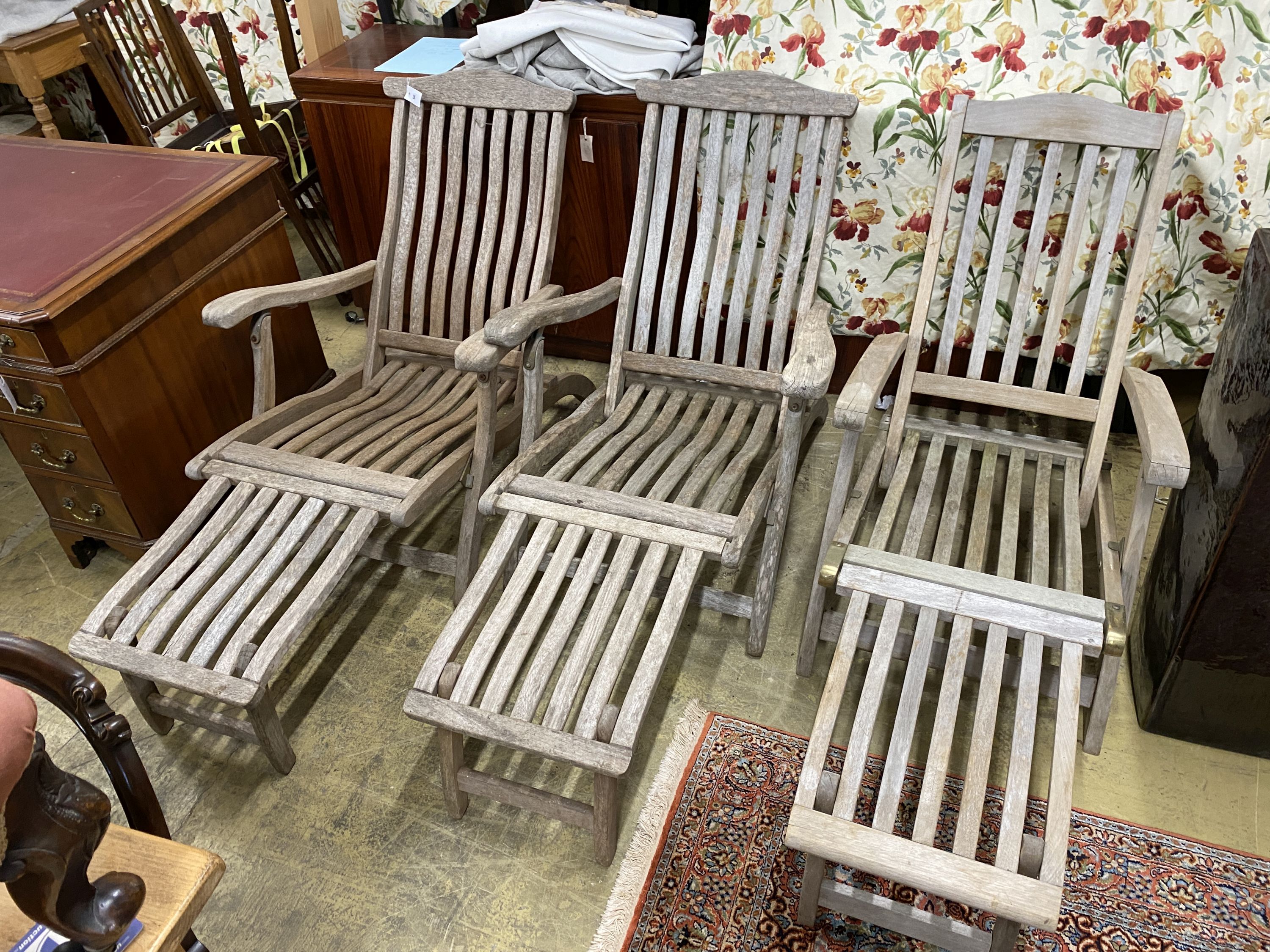 A pair of Alexander Rose teak folding steamer chairs and one other similar chair (3)